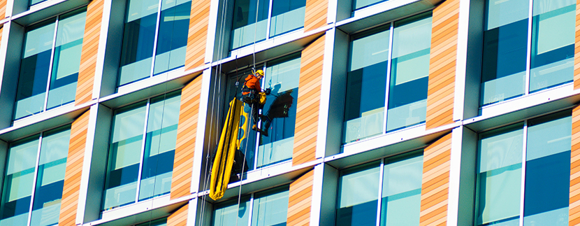 window cleaner on tall office building